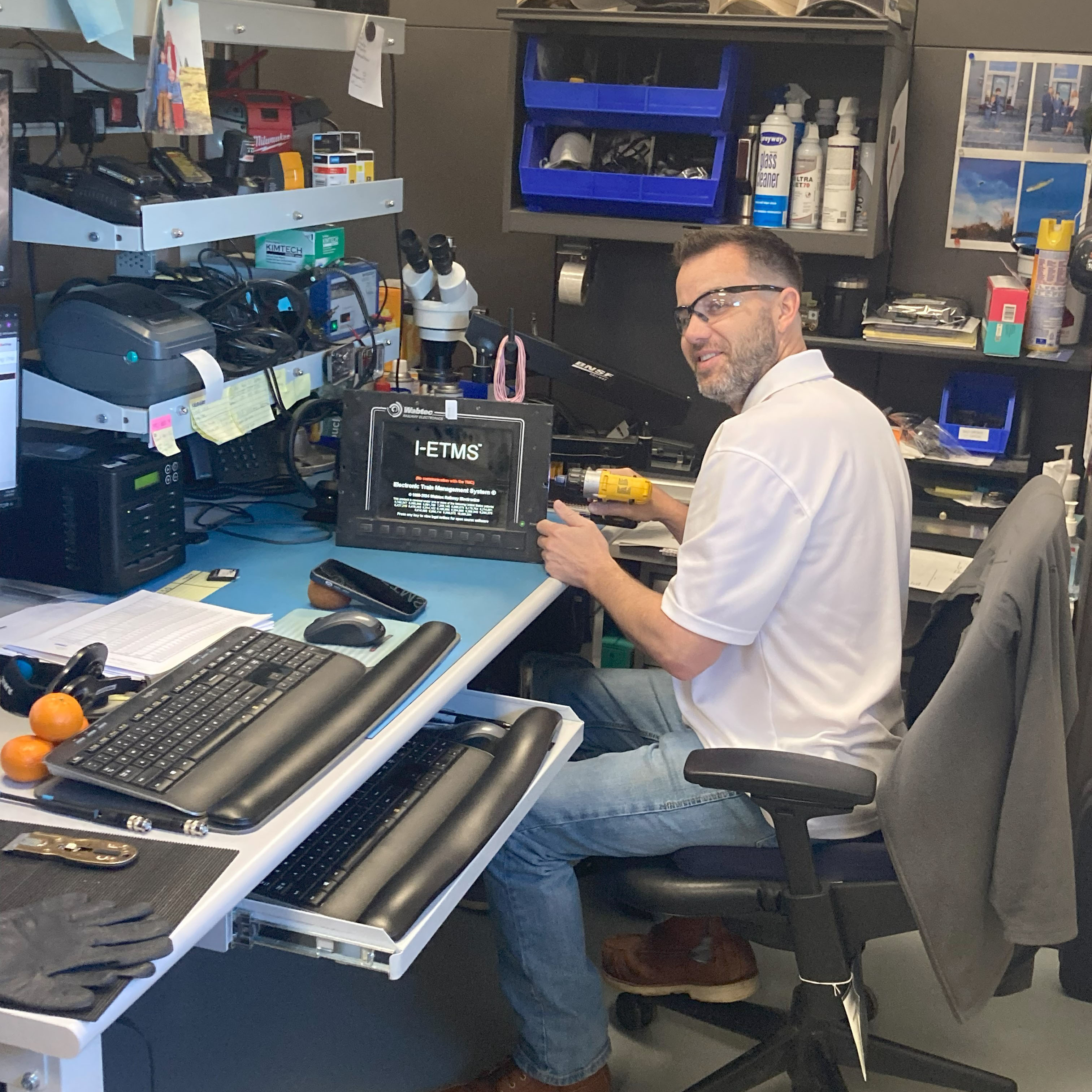 Curtis Faulconer, electronic technician II, repairs an I-ETMS console. Curtis Faulconer, electronic technician II, repairs an I-ETMS console.